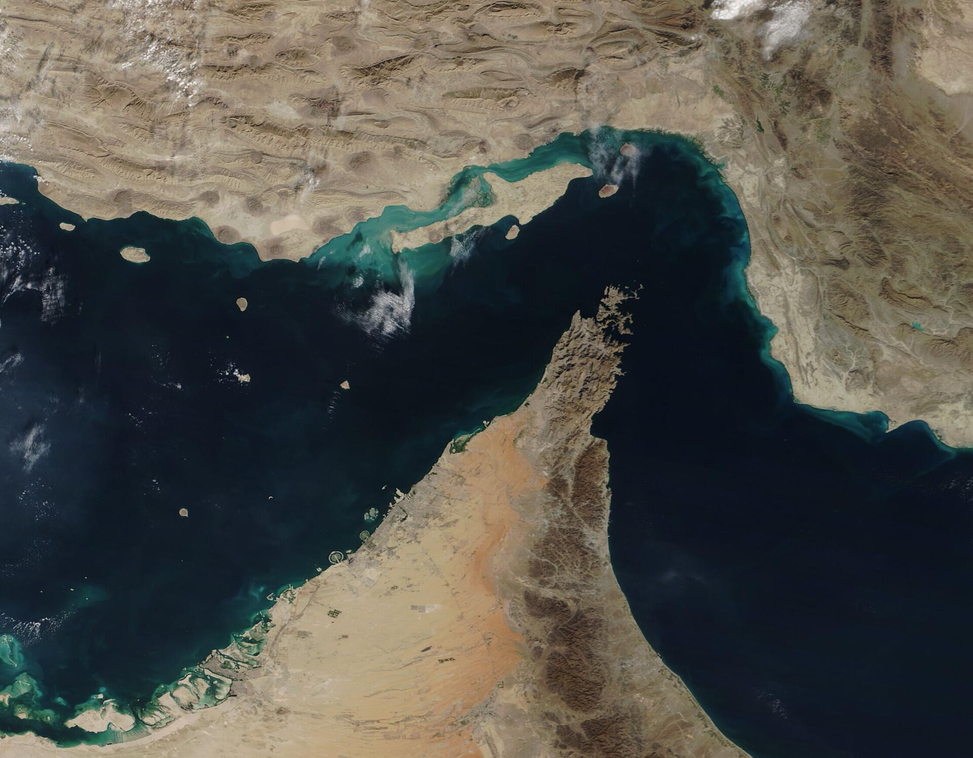 A satellite photograph of the Strait of Hormuz, the narrow waterway separating Iran from the Arabian Peninsula.